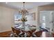Dining room with modern chandelier, glass table, and view into another room at 3434 S Race St, Englewood, CO 80113