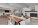 Bright living room with modern fireplace, wood accents, comfortable seating, and adjoined to dining and kitchen area at 3434 S Race St, Englewood, CO 80113