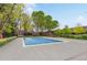 Community pool surrounded by landscaping, trees, and greenery at 3434 S Race St, Englewood, CO 80113