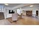 A large recreation room with stairs, chairs, tables and a ping pong table at 3434 S Race St, Englewood, CO 80113