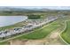 Aerial view of a beautiful lakeside community with well-manicured lawns, golf course, and picturesque landscaping at 2932 Heron Lakes Pkwy, Berthoud, CO 80513