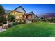 Landscaped backyard featuring a covered patio and pergola, ideal for enjoying outdoor living and dining at 2932 Heron Lakes Pkwy, Berthoud, CO 80513