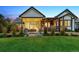 Beautiful backyard featuring covered patio, pergola, and lush landscaping, perfect for outdoor entertaining and relaxation at 2932 Heron Lakes Pkwy, Berthoud, CO 80513