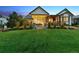 Well-maintained backyard with expansive lawn, inviting outdoor seating, and mature landscaping offering privacy and tranquility at 2932 Heron Lakes Pkwy, Berthoud, CO 80513