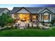 Exterior view of the backyard featuring a covered patio, hot tub, and professional landscaping at 2932 Heron Lakes Pkwy, Berthoud, CO 80513