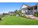 Manicured backyard with lawn and patio features a hot tub and outdoor seating at 2932 Heron Lakes Pkwy, Berthoud, CO 80513