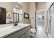 Bathroom featuring a sleek vanity with modern fixtures, white tile shower with dark trim at 2932 Heron Lakes Pkwy, Berthoud, CO 80513