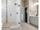 Walk-in shower with glass door, rain shower head, and white subway tile with decorative accents at 2932 Heron Lakes Pkwy, Berthoud, CO 80513