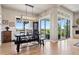 Stylish dining room featuring a rustic table set, contemporary lighting, and sliding glass doors with a view at 2932 Heron Lakes Pkwy, Berthoud, CO 80513
