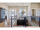 Elegant foyer with a statement chandelier, wooden floors, and an open staircase at 2932 Heron Lakes Pkwy, Berthoud, CO 80513