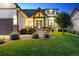Charming home exterior with a well-manicured lawn and inviting front porch, creating a welcoming curb appeal at 2932 Heron Lakes Pkwy, Berthoud, CO 80513