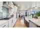 Well-lit kitchen with white cabinetry, stainless steel appliances, and a view into the dining area at 2932 Heron Lakes Pkwy, Berthoud, CO 80513