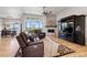 Comfortable living room featuring hardwood floors, a fireplace, and picturesque views of the outdoors at 2932 Heron Lakes Pkwy, Berthoud, CO 80513