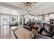 Spacious living room with hardwood floors, an open staircase, and a view of the modern kitchen at 2932 Heron Lakes Pkwy, Berthoud, CO 80513