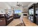 Inviting living room with comfortable seating, a cozy fireplace, and scenic golf course views at 2932 Heron Lakes Pkwy, Berthoud, CO 80513