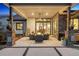 Inviting covered patio with comfortable seating, a fire pit, and stone accents at 2932 Heron Lakes Pkwy, Berthoud, CO 80513