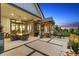 Back patio with lounge seating, a fire pit, and landscape views at 2932 Heron Lakes Pkwy, Berthoud, CO 80513