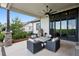 This covered patio has a ceiling fan and a fire pit with outdoor seating at 2932 Heron Lakes Pkwy, Berthoud, CO 80513