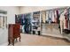 Organized walk-in closet with hanging rods, shelving, and a jewelry armoire at 2932 Heron Lakes Pkwy, Berthoud, CO 80513