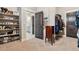 Spacious walk-in closet with shelves and dark wood doors, with bathroom access at 2932 Heron Lakes Pkwy, Berthoud, CO 80513