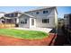 Backyard featuring green grass, stone landscaping, and neutral colored home at 7812 Blue Water Ln, Castle Rock, CO 80108