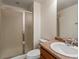 Bathroom featuring a glass-enclosed shower, single sink, and a neutral color scheme at 7812 Blue Water Ln, Castle Rock, CO 80108