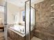 Luxurious bathroom featuring a soaking tub, glass shower, and tiled walls at 7812 Blue Water Ln, Castle Rock, CO 80108