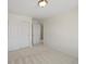 A light-filled bedroom featuring neutral carpet and a spacious closet at 7812 Blue Water Ln, Castle Rock, CO 80108