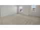 Spacious bedroom featuring neutral carpet, two windows for ample natural light at 7812 Blue Water Ln, Castle Rock, CO 80108