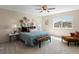 Comfortable bedroom with a cozy bed, stylish decor, ceiling fan, and a bright window at 7812 Blue Water Ln, Castle Rock, CO 80108