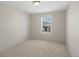 Bright bedroom with a window overlooking a pool, carpet flooring and neutral decor at 7812 Blue Water Ln, Castle Rock, CO 80108