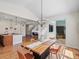 Bright dining room with wood floors, backyard view, and modern chandelier lighting at 7812 Blue Water Ln, Castle Rock, CO 80108