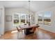 Bright dining room with a modern chandelier, hardwood floors, large windows, and view of the backyard at 7812 Blue Water Ln, Castle Rock, CO 80108
