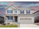Lovely two-story house featuring a welcoming porch and a spacious two-car garage at 7812 Blue Water Ln, Castle Rock, CO 80108