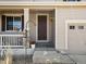 Inviting front entrance with a covered porch, decorative stone pillars, and a well-maintained walkway at 7812 Blue Water Ln, Castle Rock, CO 80108