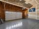 Two-car garage with overhead storage and epoxy flooring for added durability at 7812 Blue Water Ln, Castle Rock, CO 80108
