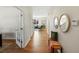 Hallway leading to living room features wood floors and stylish wall decor at 7812 Blue Water Ln, Castle Rock, CO 80108