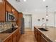 Bright kitchen with hardwood floors, tile backsplash, and a view of modern stainless steel appliances at 7812 Blue Water Ln, Castle Rock, CO 80108