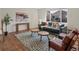 Cozy living room featuring hardwood floors, patterned rug and lots of natural light at 7812 Blue Water Ln, Castle Rock, CO 80108