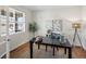 Home office with black desk, stylish lighting and lots of natural light at 7812 Blue Water Ln, Castle Rock, CO 80108