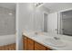 Bright bathroom featuring double sinks, vanity, and shower with tub at 9690 Lansing Cir, Commerce City, CO 80022