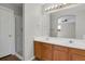 Bright bathroom features a double vanity with an adjacent glass-enclosed shower at 9690 Lansing Cir, Commerce City, CO 80022