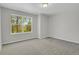 Light bedroom with neutral walls, plush carpeting, and a window that lets in ample light at 9690 Lansing Cir, Commerce City, CO 80022