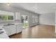 Bright living room features wood floors, large windows, and sliding glass door to the backyard at 9690 Lansing Cir, Commerce City, CO 80022