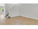 Bright, open living room with new vinyl floors and staircase at 9690 Lansing Cir, Commerce City, CO 80022