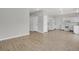 Open living room with new vinyl floors next to the kitchen at 9690 Lansing Cir, Commerce City, CO 80022