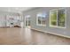 Bright and airy living room featuring new vinyl floors and a view of the backyard through sliding glass doors at 9690 Lansing Cir, Commerce City, CO 80022
