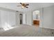 Primary bedroom with carpet, a closet and an archway to the ensuite bathroom at 9690 Lansing Cir, Commerce City, CO 80022
