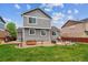 Well-maintained backyard featuring a patio, lawn, and tasteful landscaping, perfect for outdoor entertaining at 25850 E 3Rd Ave, Aurora, CO 80018