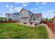 Backyard with a patio, grill, and well maintained lawn at 25850 E 3Rd Ave, Aurora, CO 80018